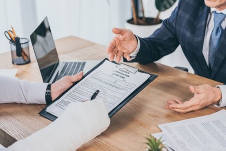 man with arm cast talking to an attorney