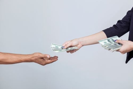 woman handing a man money